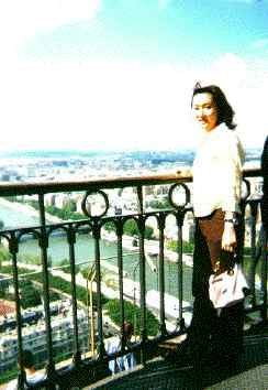 Yumiko looks down at the Seine from the Eiffel Tower